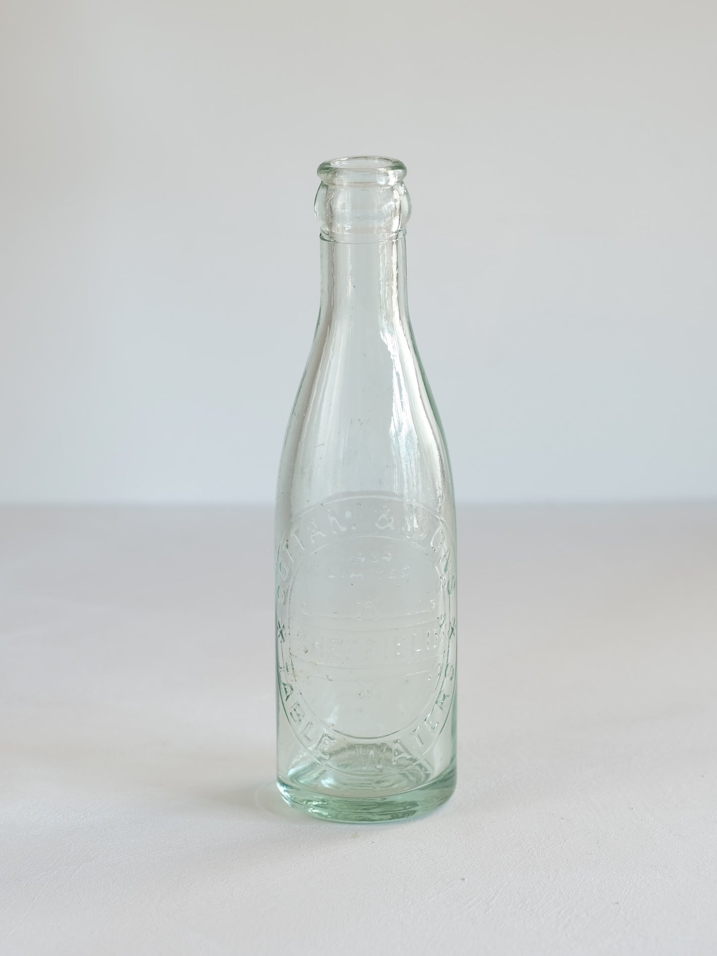 Cottam & Sons   Embossed Glass Bottle